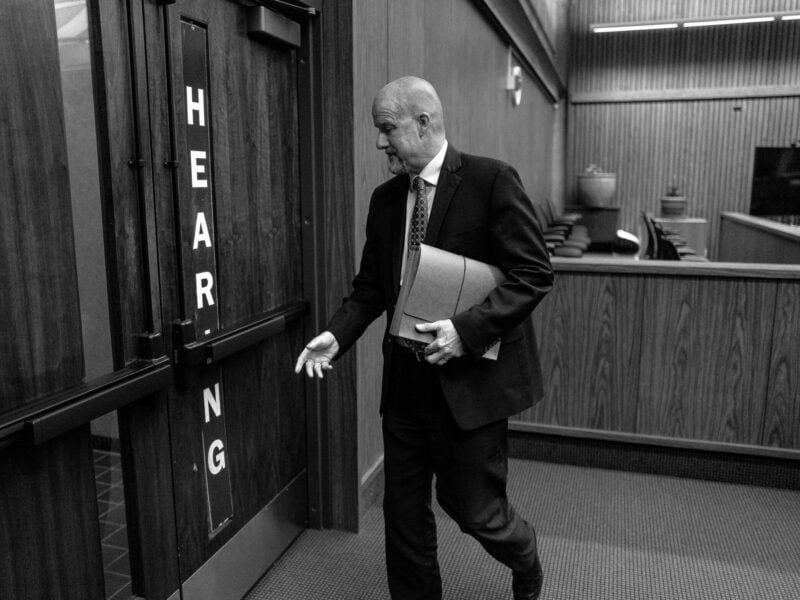 A white male lawyer with a shaved head in his 50s or 60s leaves a hearing in Solano County Superior Court.